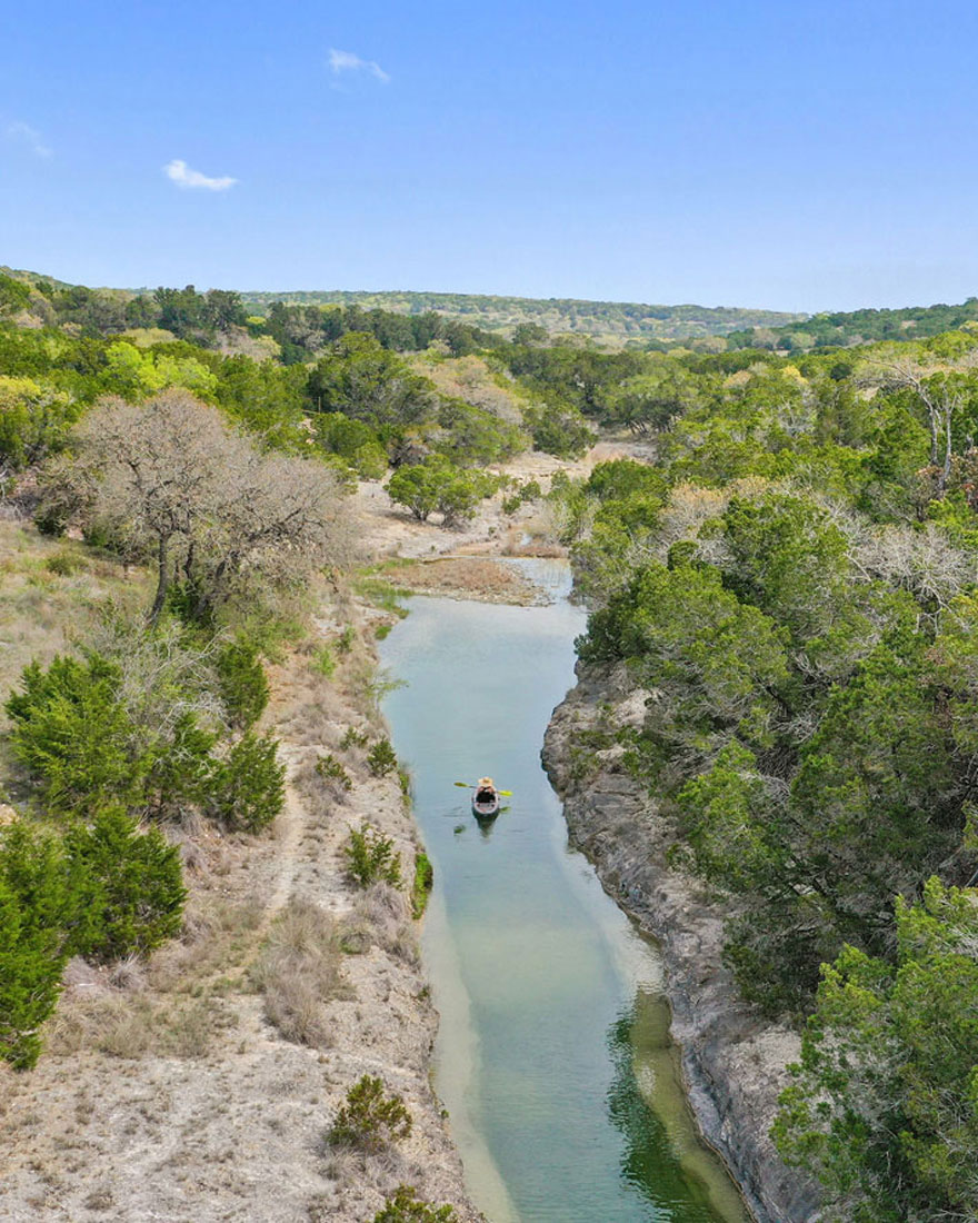 Aerial view of winding river through Texas Hill Country landscape